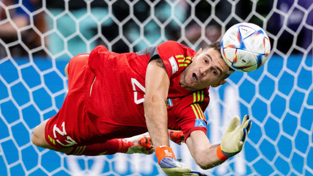 Argentina goalkeeper Emiliano Martinez pictured making a save during his side's penalty-shootout win over Holland at the 2022 World Cup